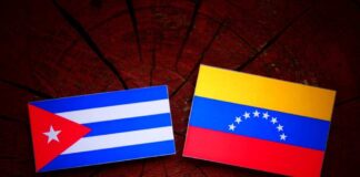 Cuban and Venezuelan flags displayed on a wooden surface