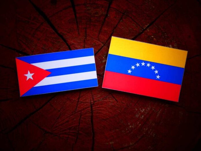 shutterstock_683196424.jpg Cuban and Venezuelan flags displayed on a wooden surface
