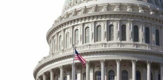 U.S. Capitol dome with American flag flying.