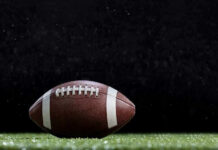 Close-up of a football on a grassy field.