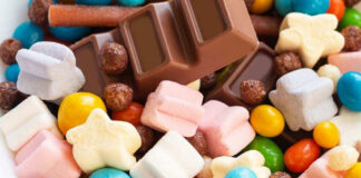 Colorful candies and chocolate bar close-up.