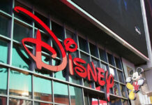 Disney sign on building with Mickey Mouse figure