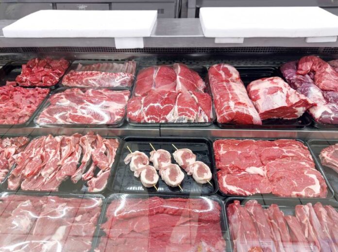 Variety of fresh meats displayed in a butcher shop