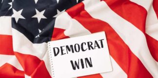 A notepad with the words 'DEMOCRAT WIN' placed on an American flag