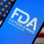 FDA logo on smartphone American flag background
