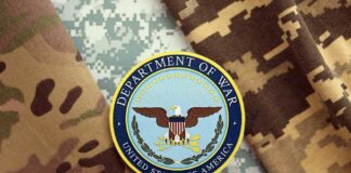 Department of War insignia on camouflage fabric