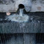 Water flowing from a pipe into a basin
