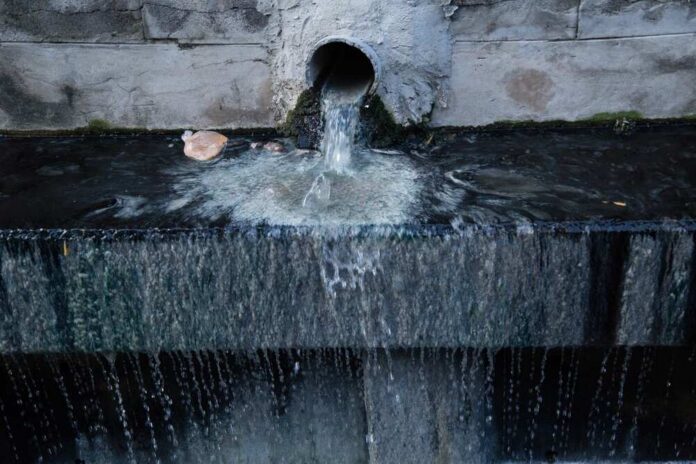 Water flowing from a pipe into a basin