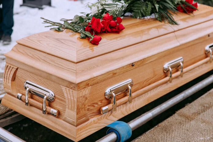 shutterstock2423034429jpg Wooden casket with red roses on top