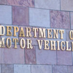 Sign for the Department of Motor Vehicles on a stone wall