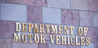 Sign for the Department of Motor Vehicles on a stone wall