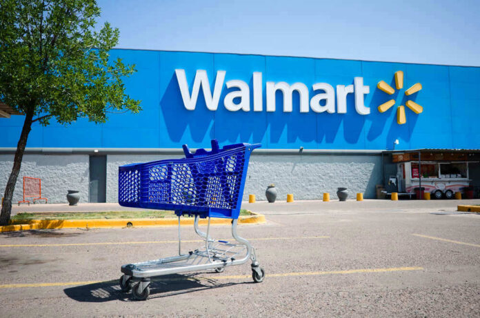 shutterstock_1871096929.jpg Shopping cart in a Walmart parking lot.