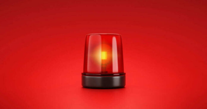 Red emergency light on red background