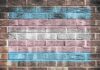 Transgender pride flag painted on a brick wall