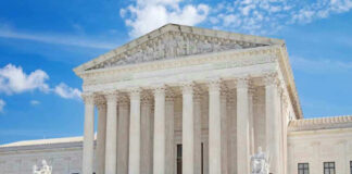 United States Supreme Court building with statues and columns.