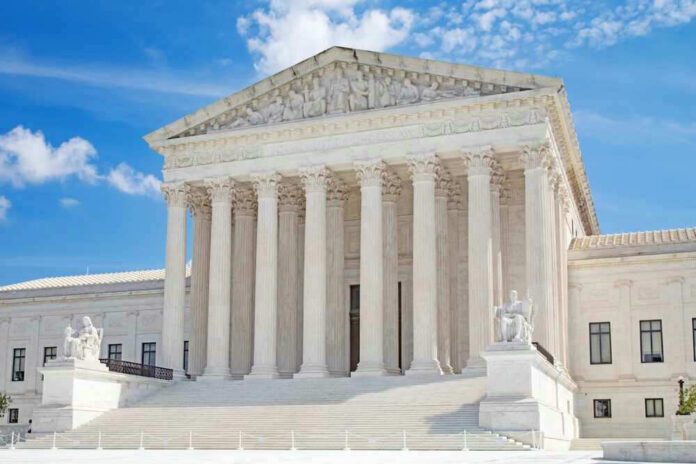 United States Supreme Court building with statues and columns.