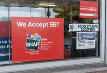 Store window displays EBT and SNAP acceptance signs