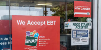 Store window displays EBT and SNAP acceptance signs