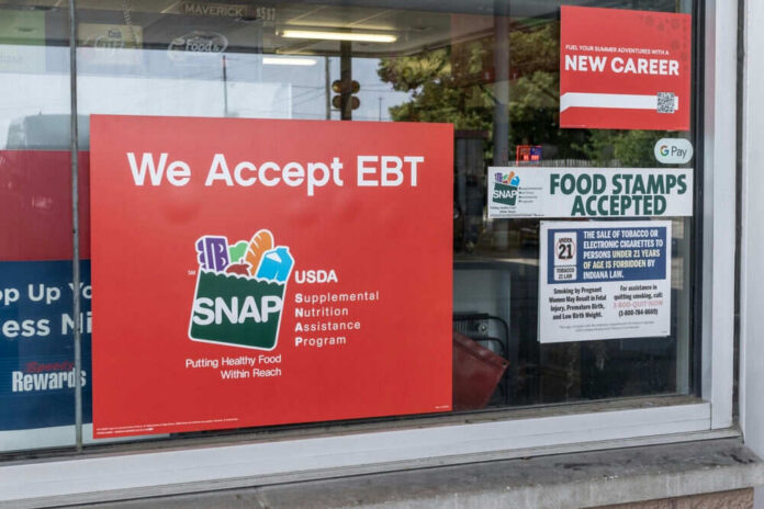 Store window displays EBT and SNAP acceptance signs