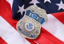 ICE officer badge resting on an American flag