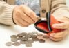 Inflation Forces Mass 401(k) Grabs Elderly person placing a coin into a red coin purse