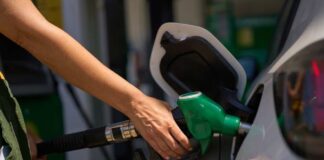 Person refueling a car at a gas station