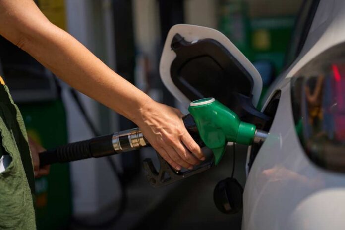 Person refueling a car at a gas station