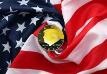 A gold coin featuring a profile and the year 2024, placed on a wrinkled American flag