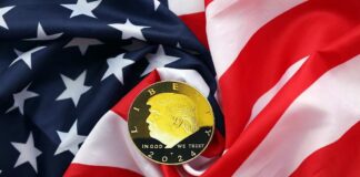 A gold coin featuring a profile and the year 2024, placed on a wrinkled American flag
