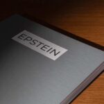 Close-up of a metallic binder labeled 'EPSTEIN'