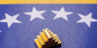 Stack of gold bars on a Venezuelan flag background