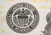 Close-up of the Federal Reserve System seal on a banknote