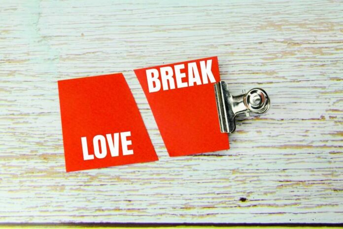 Two red cards with the words 'LOVE' and 'BREAK' separated by a clip