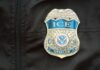 Military Base Drama: ICE Nabs Soldier’s Bride Close-up of an ICE officer badge on a black jacket