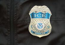 Close-up of an ICE officer badge on a black jacket