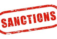 Red stamp with the word 'SANCTIONS' in bold letters