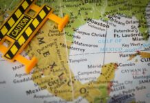 A caution sign placed on a map highlighting Mexico and the Gulf of Mexico