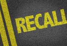 RECALL: Popular Drinks CONTAMINATED Yellow 'RECALL' text on a dark asphalt surface