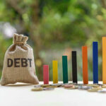 Debt sack with rising financial graph bars.