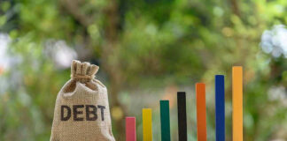 Debt sack with rising financial graph bars.