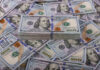Stack of one hundred dollar bills, Benjamin Franklins portrait.