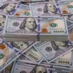 Bezos’ Bold Call: Scrap Taxes for THIS 50% of Americans Stack of one hundred dollar bills, Benjamin Franklins portrait.