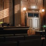 Supreme Court’s Reversal Stuns Liberals Interior of a courtroom with wooden paneling and green desk lamp