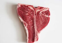Memorial Day SHOCKER: Grocery Bills Sizzle! Raw T-bone steak on a white background