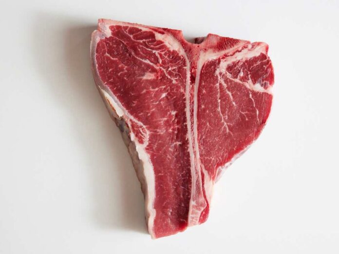 Top,Shot,Of,Delicious,Raw,Red,Beef,Meat,Placed,On Raw T-bone steak on a white background