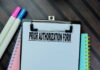 Clipboard with a prior authorization form and colorful markers