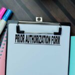 Clipboard with a prior authorization form and colorful markers