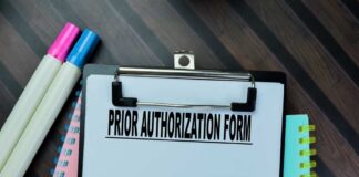 Clipboard with a prior authorization form and colorful markers