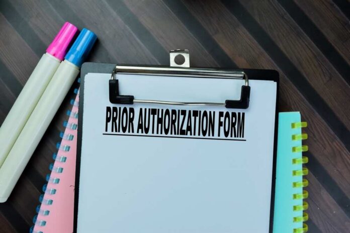 shutterstock_2294213029.jpg Clipboard with a prior authorization form and colorful markers