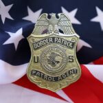 Border Patrol Shake-Up: He Quit! Border Patrol badge resting on an American flag
